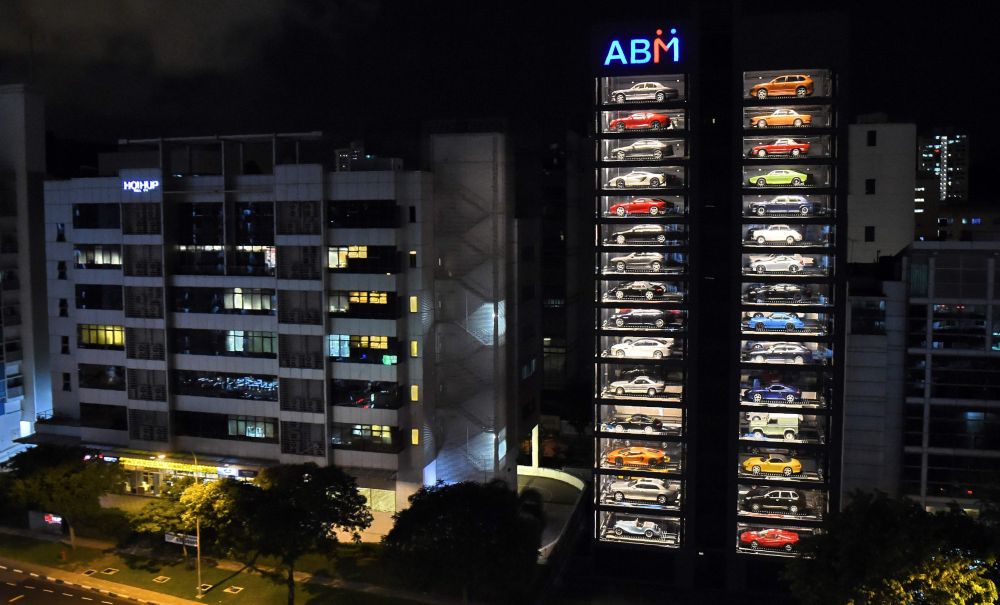 Luxury supercars are displayed inside the AutoBahn Motors (ABM) building in Singapore on May 18, 2017. The building, which resembles an automobile 'vending machine' houses 60 of the million-dollar supercars owned by ABM owners Gary and Jack Hong, who invented the Automotive Inventory Management System (AIMS). / AFP PHOTO / ROSLAN RAHMAN